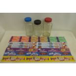 Three glass sweetie jars and a selection of rectangular window strips advertising various