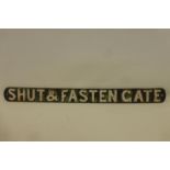 An original cast iron railway sign - "Shut and Fasten Gate", 33 1/2 x 3".