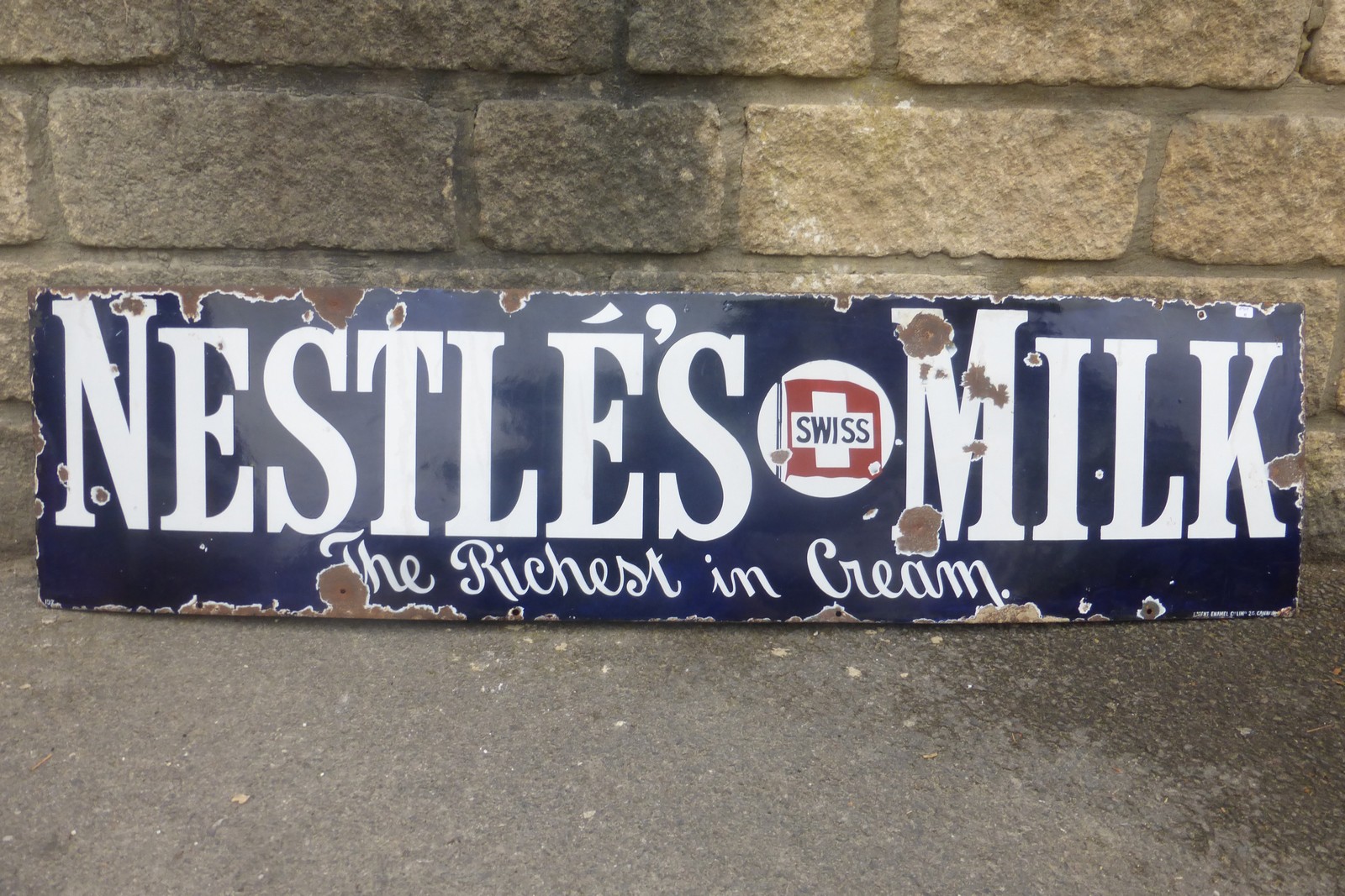 A Nestle's Milk "the richest in cream" rectangular enamel sign, 48 1/2 x 12".