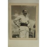 A Stirling Moss signed black and white photograph, circa 1950 8 1/4 x 10 1/2".