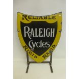 A Raleigh Cycles "Reliable, Rigid and Rapid" shield shaped enamel sign, mounted on a metal stand, 17