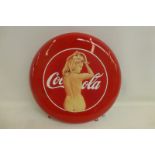 A Coca Cola red enamel circular sign, by Mel Ramos (USA artist), with advertising figure of Ursula