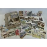 A box of assorted postcards, some early, some world and some military.
