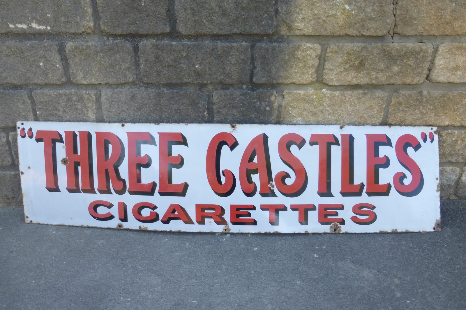 A "Three Castles" cigarettes enamel sign, 60 x 15".