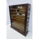A Singleton & Cole cigarettes counter top cabinet unusually the seven drawers opening at both