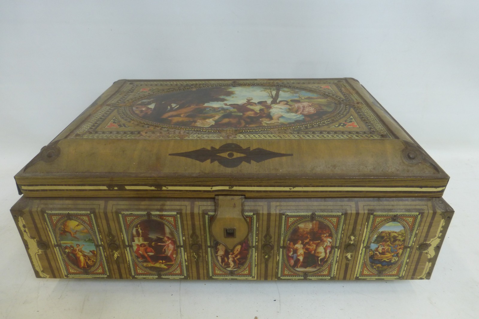 A large rectangular embossed tin decorated with classical scenes.