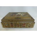 A large rectangular embossed tin decorated with classical scenes.