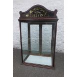 A shop counter top rear opening display cabinet with pediment advertising Henderson's Biscuits &