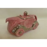 A Sadler teapot in the form of a motor car, pink version.