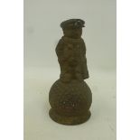 An original brass Dunlop counter top bell in the form of a "man-caddy" sat on a golf ball.