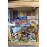 Two shelves of assorted tins and packaging, mostly confectionary related including Cadbury's,