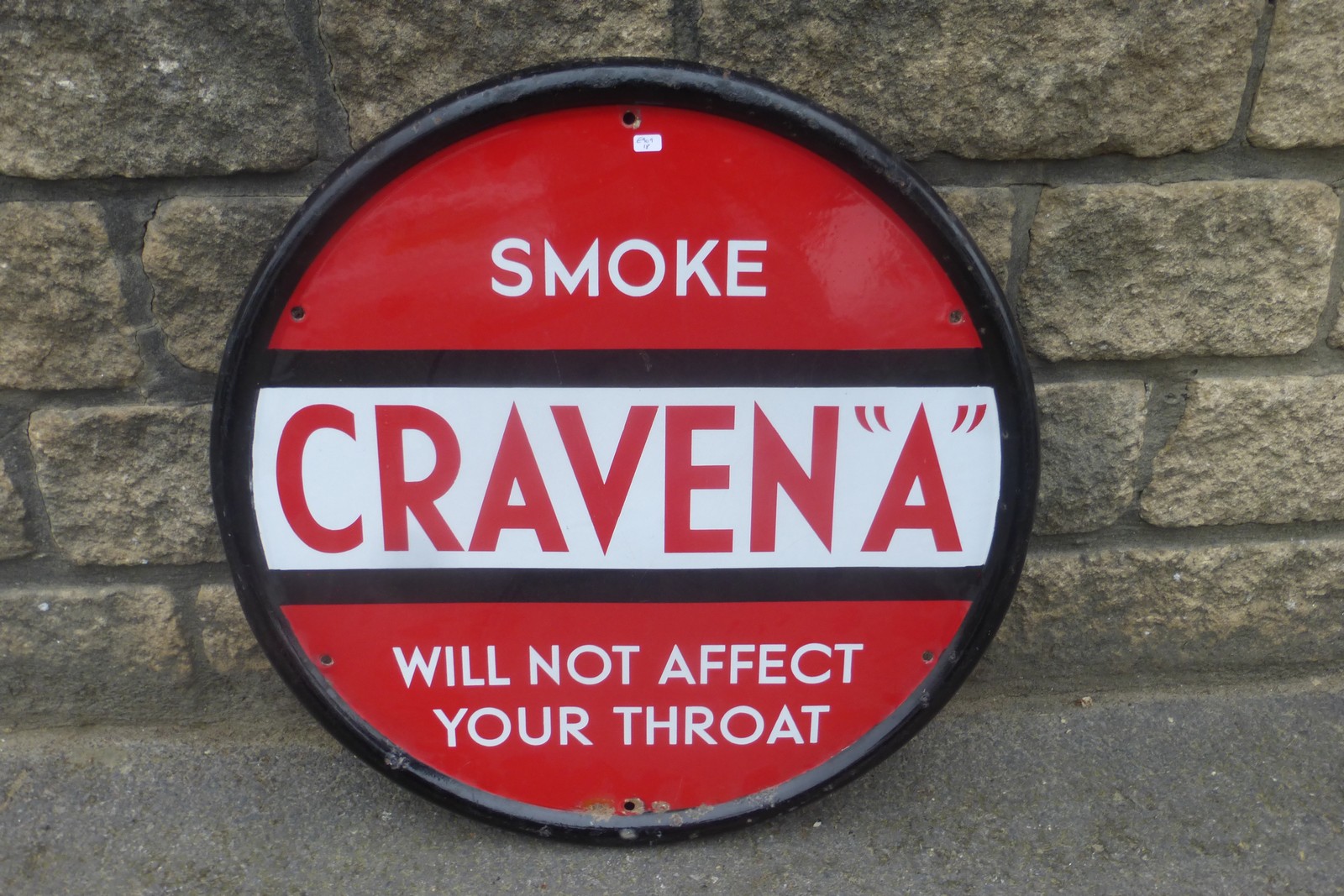 A Craven A "will not affect your throat" circular enamel sig, with very good gloss, 23 1/4"