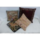 A carpet/kelim covered cushion and three others.