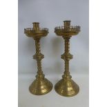 A pair of 19th century brass ecclesiastical style candlesticks with barley twist columns to a