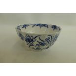 An 18th Century Worcester blue and white tea bowl (hairline) bearing the blue crescent mark.