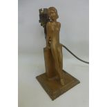 An Art Deco table light formerly a match striker, designed by LORENZL, modelled as a nude resting