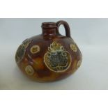 An unusual Royal Doulton squat stoneware decanter with five inset leaf motifs amongst an autumnal