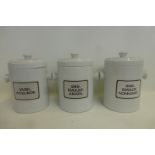 Three ceramic lidded twin handled chemist's storage jars.