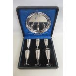 A cased Walker & Hall circular silver plated drinks tray and six miniature goblets with engine