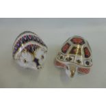 A Royal Crown Derby tortoise with gold button and a Hedgehog, also with gold button.