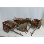 Three large good quality wooden and brass mounted scale model farm carts and various parts.