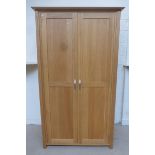 A contemporary oak two door wardrobe.