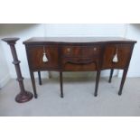 A reproduction mahogany serpentine fronted sideboard and a reprodution rope twist stem torchere.