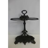 A Victorian painted cast iron umbrella stand, complete with twin handled drip tray and date