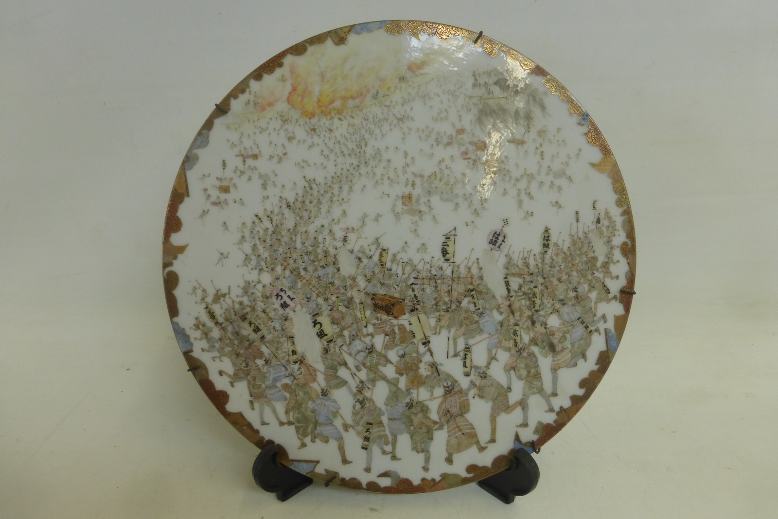 A 19th Century Japanese Satsuma circular wall charger depicting a battle scene, eight character mark