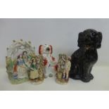 A large Victorian Staffordshire group, two 19th Century Staffordshire dogs and a pair of 19th