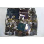 A tin of assorted world coins.