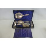 A cased five piece silver backed dressing table set, maker Deakin & Fransis, Birmingham 1919.