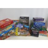 A collection boxed games and puzzles including 'Rummikub'.
