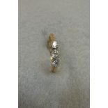 An 18ct gold and platinum three stone diamond ring, approx. 0.3cts. Size N.