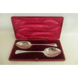 A pair of silver plated berry spoons, cased with silk and velvet lined interior.