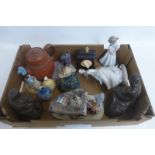 An assortment of ceramic and studio figurines including an E. Tezza lady playing a piano.