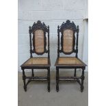 A pair of carved oak and cane seated hall chairs with H stretchers.