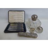 A large cut glass and silver topped inkwell, a cased set of six silver handled knives, a silver