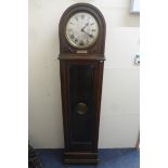 A 1920s oak cased longcase clock with silvered circular dial and presentation plaque for 1927.