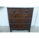 A Victorian mahogany chest of two short over three long drawers with shaped apron and bracket