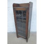 A Liberty & Co. oak narrow bookcase with leaded glazed door.