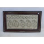 A 19th Century framed and glazed needlework panel with gold thread.