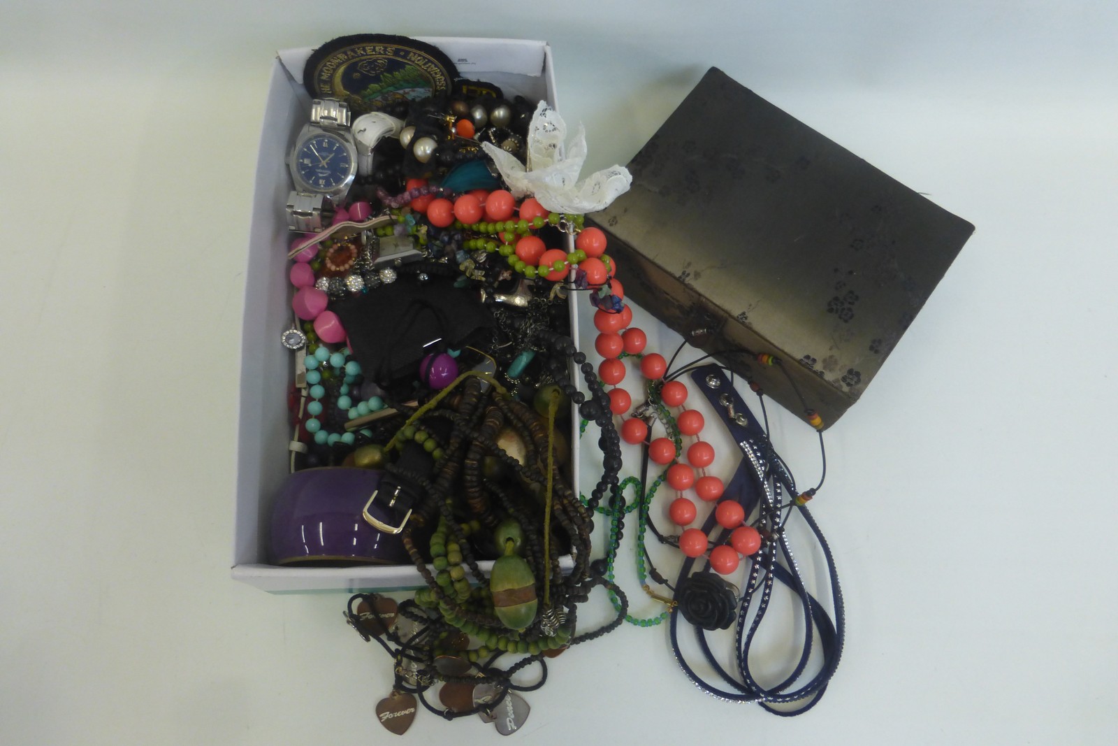 A box of assorted costume jewellery including a silk covered jewellery box.