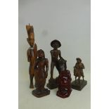 Five assorted wooden carvings including a highly polished buddha.