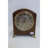 An Edwardian mahogany and barber pole strung dome topped mantle clock of small size raised upon