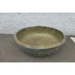 A very large hammered brass shallow bowl, 19th Century or earlier.