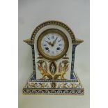 A faience porcelain mantle clock, the case by Gien decorated with classical iconography, the