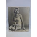 A 1960s print of a seated young lady.