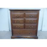 An 18th Century style oak chest of two short over three long drawers to a shaped apron.