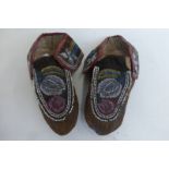 A pair of 19th Century North American Indian beadwork, velvet and leather mocassins decorated with